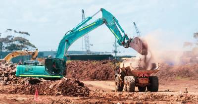 Excavator digging and loading